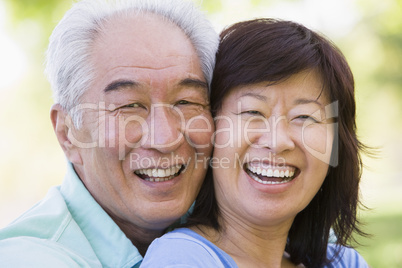 Couple relaxing outdoors in park laughing