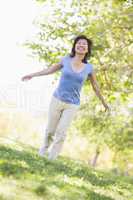 Woman walking outdoors smiling