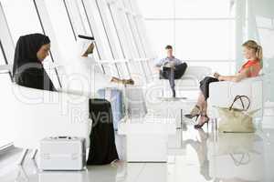 Passengers waiting in airport departure lounge