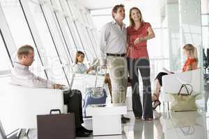 Passengers waiting in airport departure lounge