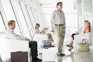 Passengers waiting in airport departure lounge