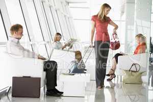 Passengers waiting in airport departure lounge