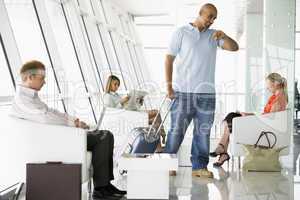 Passengers waiting in airport departure lounge