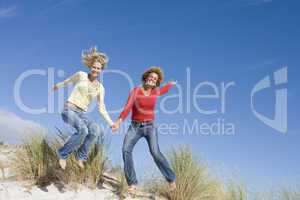 Two female friends having fun on beach