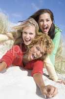 Three female friends having fun at beach