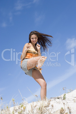 Young woman exercising on beach