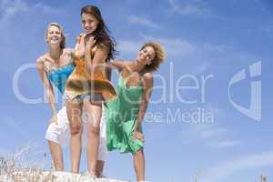 Three female friends relaxing at beach