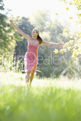 Young woman walking through countryside