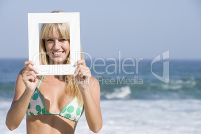 Woman looking through empty frame