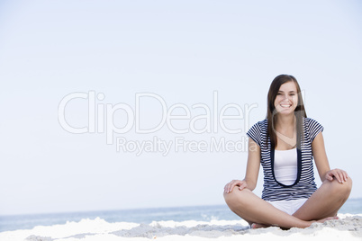 Young woman sitting on beach