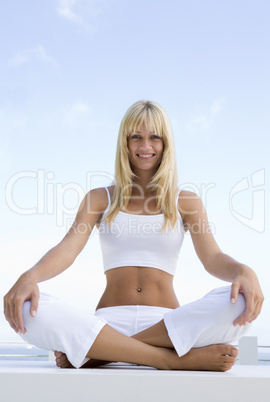 Young woman sitting cross legged