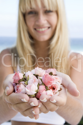 Woman holding handful of flower buds