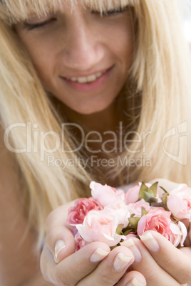 Woman holding handful of buds