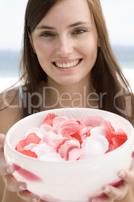 Woman holding bowl of petals