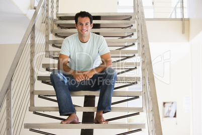 Man sitting on staircase smiling