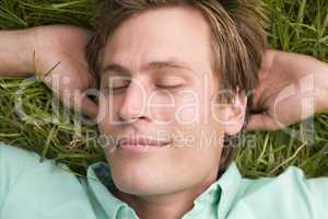 Man lying on grass sleeping