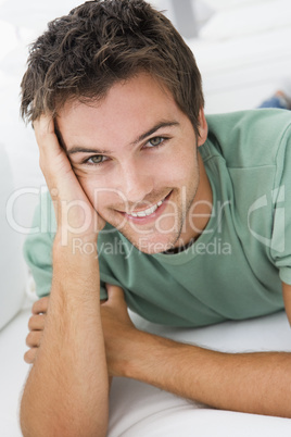 Man lying in living room smiling