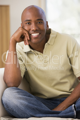 Man sitting in living room smiling