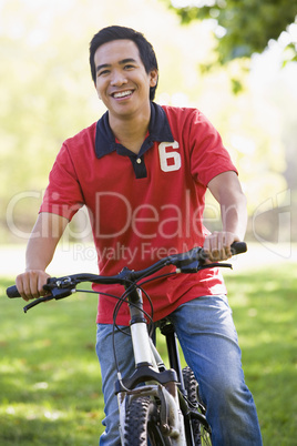 Man outdoors on bike smiling