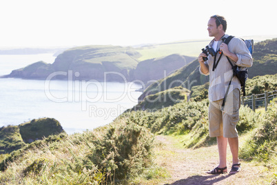 Man standing on cliffside path