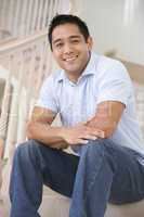 Man sitting on staircase smiling