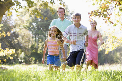 Family running outdoors smiling