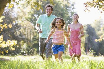 Family running outdoors smiling