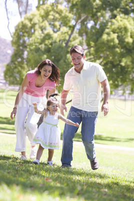 Family running outdoors smiling