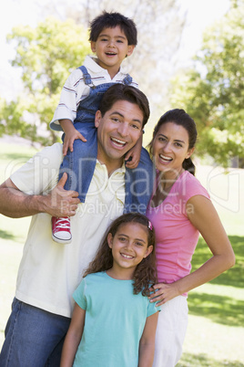 Family outdoors smiling