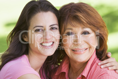 Two women standing outdoors smiling