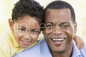 Man and young boy outdoors smiling