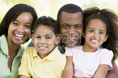 Family outdoors smiling