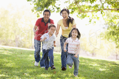 Family running outdoors smiling