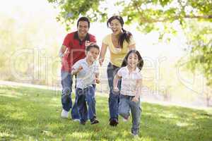 Family running outdoors smiling