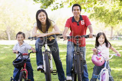 Family on bikes outdoors smiling