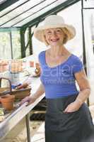 Woman in greenhouse smiling