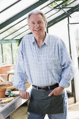 Man in greenhouse smiling