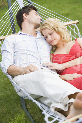 Couple sleeping in hammock