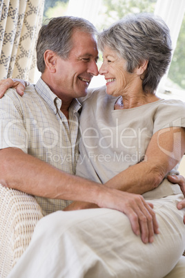 Couple relaxing in living room smiling