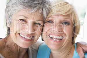 Two women in living room smiling