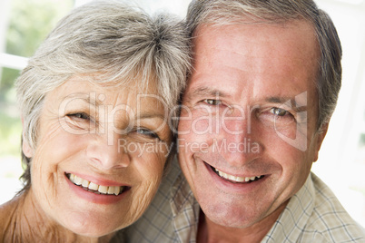 Couple relaxing indoors smiling