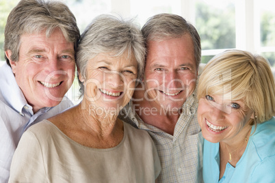 Two couples indoors smiling