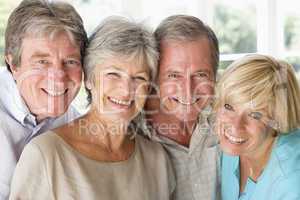 Two couples indoors smiling