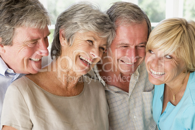 Two couples indoors smiling