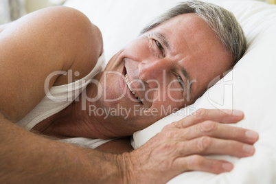 Man lying in bed smiling