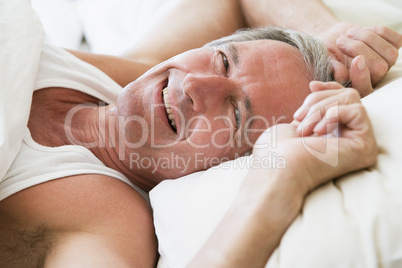 Man lying in bed smiling