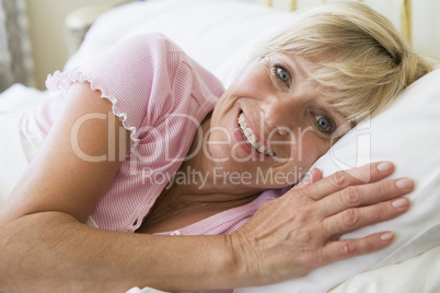 Woman lying in bed smiling