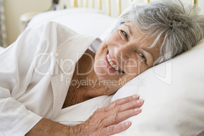 Woman lying in bed smiling