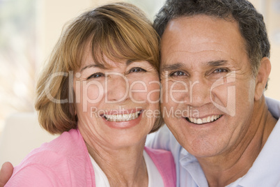 Couple relaxing in living room smiling