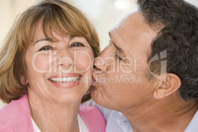 Two couples indoors smiling